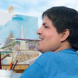 Artista deficiente demonstra sua arte pintando com a boca em vídeo